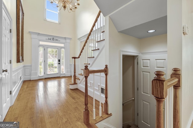 3450 Merganser Ln, Alpharetta, GA 30022 - entrance foyer featuring a chandelier, stairs, a high ceiling, and light wood finished floors