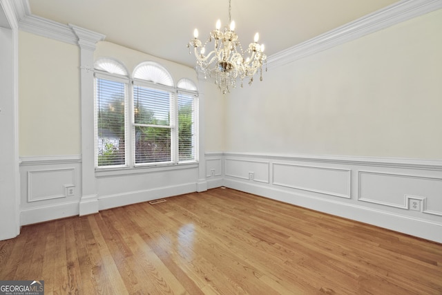 3450 Merganser Ln, Alpharetta, GA 30022 - unfurnished room featuring a chandelier, a wainscoted wall, light wood finished floors, and crown molding