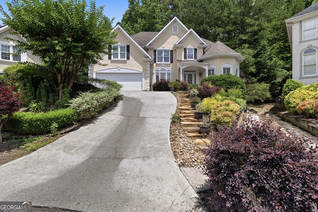 3450 Merganser Ln, Alpharetta, GA 30022 - traditional-style house featuring stucco siding, concrete driveway, and a garage