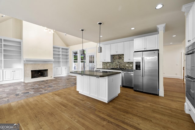 3450 Merganser Ln, Alpharetta, GA 30022 - kitchen with stainless steel appliances, dark wood-style floors, dark countertops, white cabinetry, and open floor plan