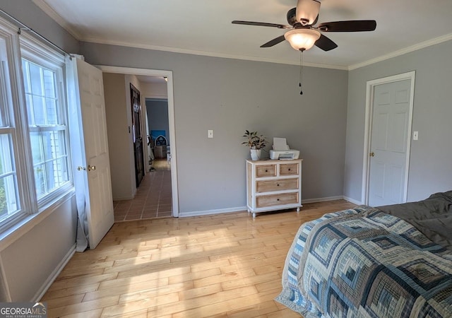 67 Wilder Dr, Forsyth, GA 31029 - bedroom with multiple windows, light wood-style floors, ornamental molding, and a ceiling fan