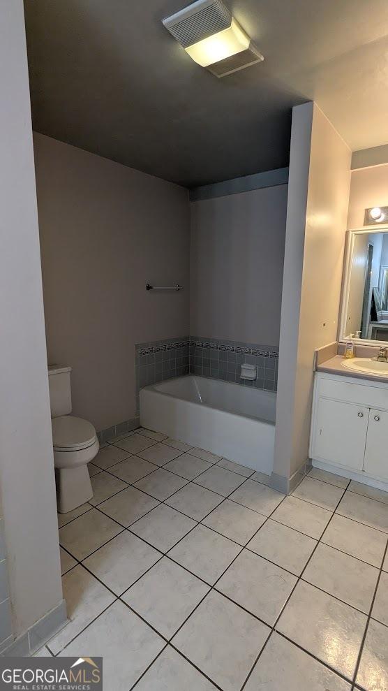 67 Wilder Dr, Forsyth, GA 31029 - bathroom with tile patterned flooring, a bath, and vanity