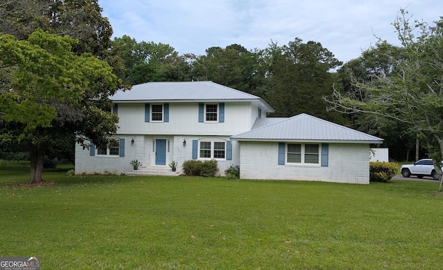 67 Wilder Dr, Forsyth, GA 31029 - view of front of home featuring brick siding, a front lawn, and a metal roof
