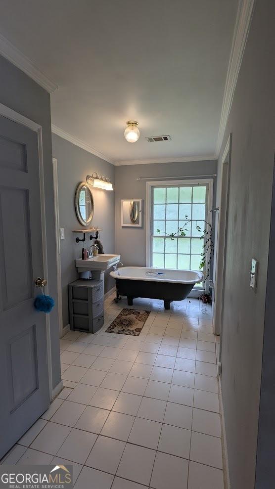 67 Wilder Dr, Forsyth, GA 31029 - full bath featuring a freestanding tub, tile patterned floors, and ornamental molding