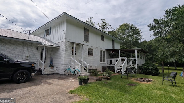 67 Wilder Dr, Forsyth, GA 31029 - back of house featuring an outdoor fire pit, brick siding, a yard, stairway, and a deck