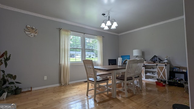 67 Wilder Dr, Forsyth, GA 31029 - dining room featuring light wood finished floors, a chandelier, and crown molding