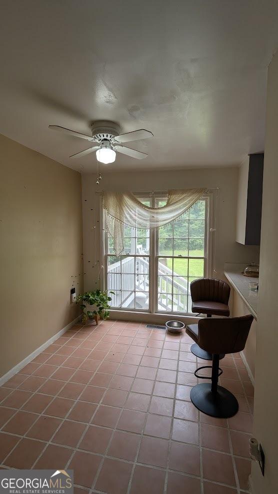 67 Wilder Dr, Forsyth, GA 31029 - living room with light tile patterned flooring and ceiling fan