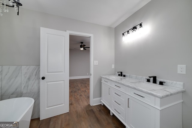 858 Pates Creek Rd, Stockbridge, GA 30281 - bathroom featuring a freestanding tub, a ceiling fan, double vanity, and wood finished floors