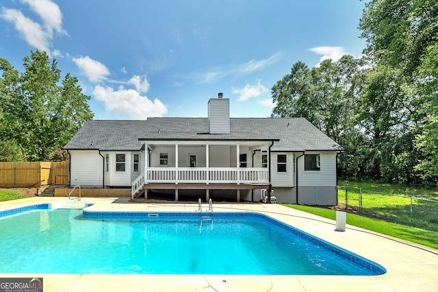 858 Pates Creek Rd, Stockbridge, GA 30281 - rear view of house featuring a wooden deck, a chimney, roof with shingles, and a patio