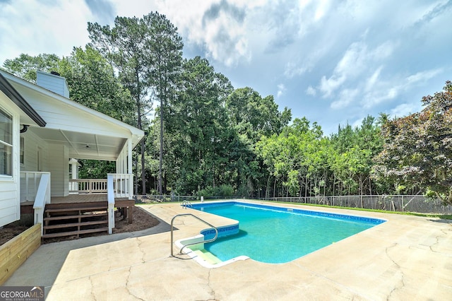 858 Pates Creek Rd, Stockbridge, GA 30281 - view of pool featuring view of wooded area, a patio area, and a wooden deck