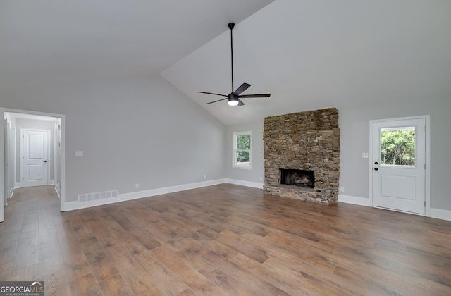 858 Pates Creek Rd, Stockbridge, GA 30281 - unfurnished living room featuring a ceiling fan, healthy amount of natural light, wood finished floors, and high vaulted ceiling