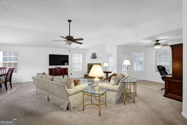 5565 Ashmoore Ct, Flowery Branch, GA 30542 - living room featuring ceiling fan, light colored carpet, and a fireplace with raised hearth