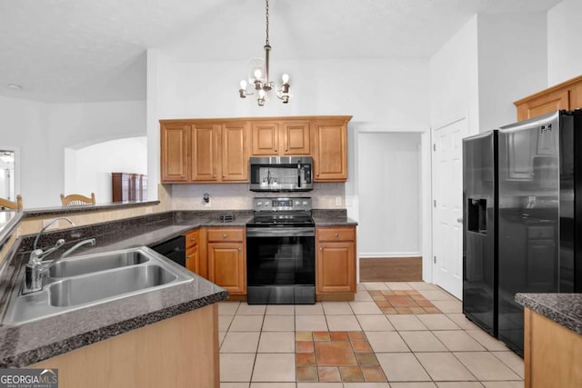 5565 Ashmoore Ct, Flowery Branch, GA 30542 - kitchen featuring appliances with stainless steel finishes, a chandelier, dark countertops, and light tile patterned flooring