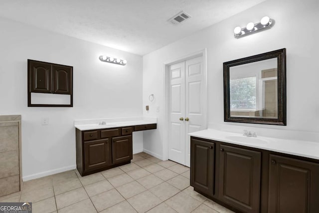 5565 Ashmoore Ct, Flowery Branch, GA 30542 - full bathroom with two vanities and tile patterned flooring