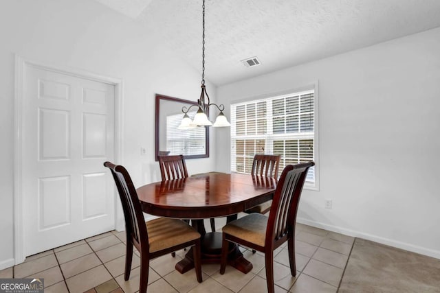 5565 Ashmoore Ct, Flowery Branch, GA 30542 - dining area with a chandelier, light tile patterned flooring, a textured ceiling, and vaulted ceiling