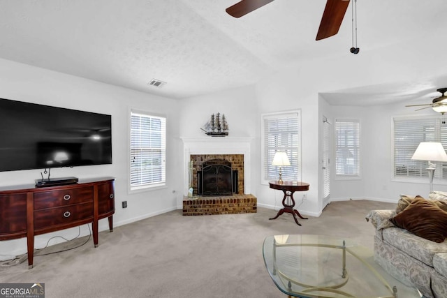 5565 Ashmoore Ct, Flowery Branch, GA 30542 - carpeted living room featuring ceiling fan and a fireplace