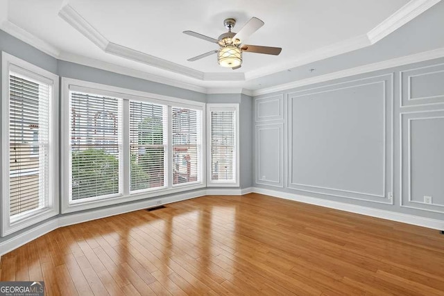 3541 Roswell Rd NE Unit 21, Atlanta, GA 30305 - spare room featuring ceiling fan, wood finished floors, crown molding, and a raised ceiling