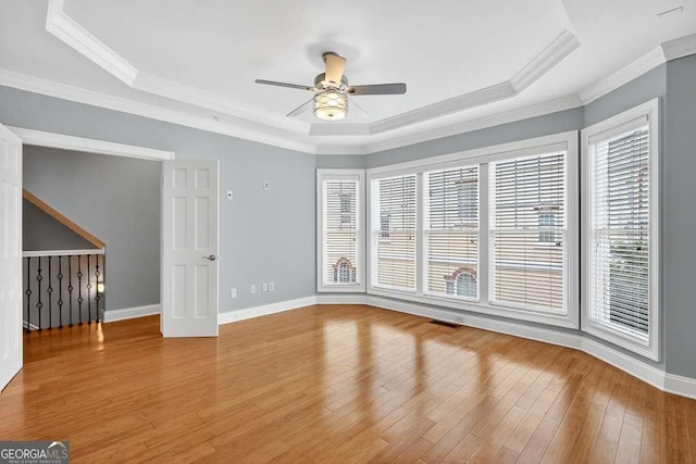 3541 Roswell Rd NE Unit 21, Atlanta, GA 30305 - unfurnished room featuring a raised ceiling, a ceiling fan, ornamental molding, and light wood-style flooring