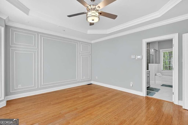 3541 Roswell Rd NE Unit 21, Atlanta, GA 30305 - unfurnished bedroom with light wood finished floors, a raised ceiling, ornamental molding, a ceiling fan, and ensuite bathroom