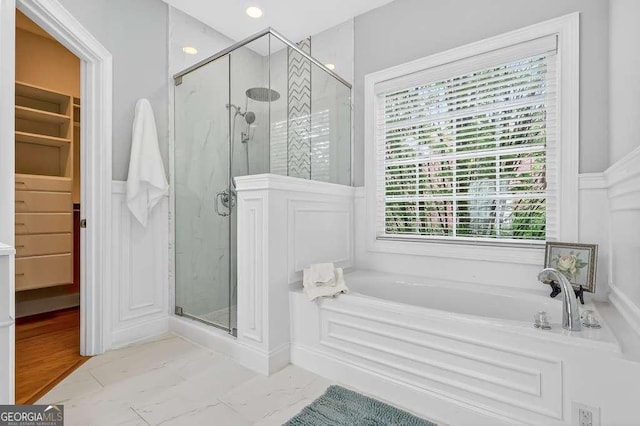 3541 Roswell Rd NE Unit 21, Atlanta, GA 30305 - full bath featuring a garden tub, a shower stall, a wainscoted wall, a decorative wall, and marble finish floors