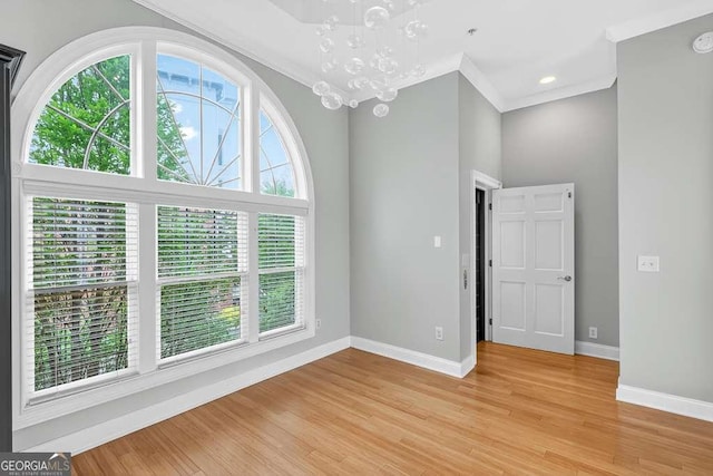 3541 Roswell Rd NE Unit 21, Atlanta, GA 30305 - empty room with a chandelier, light wood-type flooring, and ornamental molding
