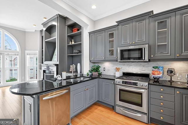 3541 Roswell Rd NE Unit 21, Atlanta, GA 30305 - kitchen with appliances with stainless steel finishes, a peninsula, ornamental molding, light wood-style flooring, and gray cabinets