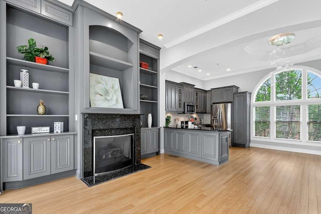 3541 Roswell Rd NE Unit 21, Atlanta, GA 30305 - kitchen featuring gray cabinetry, open shelves, stainless steel appliances, dark countertops, and light wood-style flooring