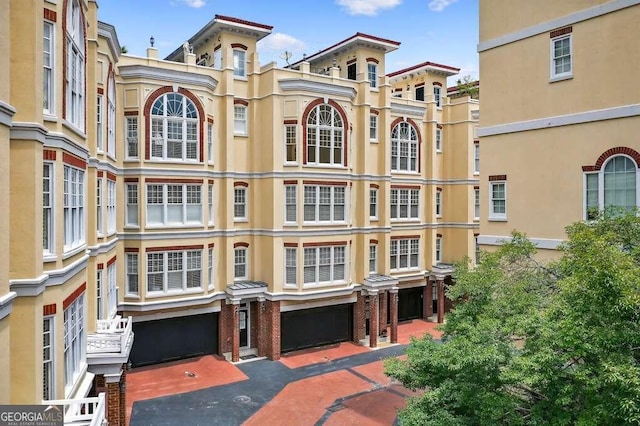 3541 Roswell Rd NE Unit 21, Atlanta, GA 30305 - view of building exterior featuring an attached garage and driveway