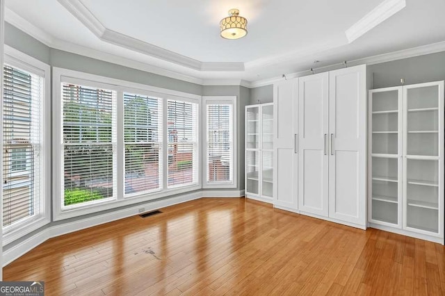 3541 Roswell Rd NE Unit 21, Atlanta, GA 30305 - spare room with healthy amount of natural light, a raised ceiling, light wood finished floors, and ornamental molding