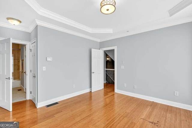 3541 Roswell Rd NE Unit 21, Atlanta, GA 30305 - unfurnished bedroom with light wood-type flooring and crown molding