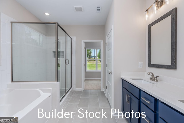LOT6 The Rock Rd, Thomaston, GA 30286 - full bath with double vanity, a shower stall, a bath, tile patterned flooring, and recessed lighting