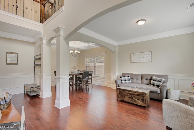 108 Village Pl, Newnan, GA 30265 - living area with decorative columns, crown molding, arched walkways, dark wood-style flooring, and a decorative wall