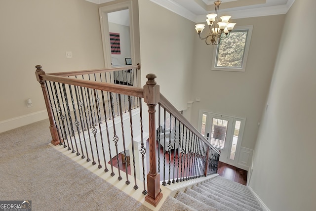 108 Village Pl, Newnan, GA 30265 - stairway with a chandelier, plenty of natural light, crown molding, and carpet floors