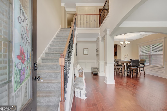 108 Village Pl, Newnan, GA 30265 - foyer featuring arched walkways, decorative columns, crown molding, wood finished floors, and stairs