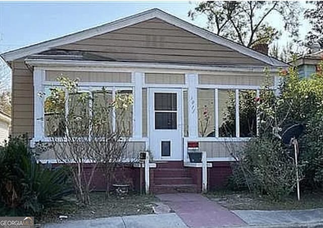 1011 Richards St, Savannah, GA 31415 - bungalow-style house with a sunroom