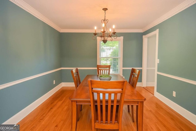 4714 Marc Ct SW, Lilburn, GA 30047 - dining space featuring a chandelier, wood finished floors, and crown molding