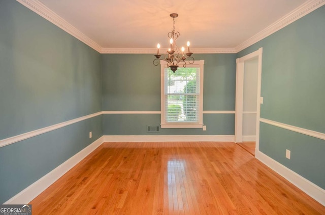 4714 Marc Ct SW, Lilburn, GA 30047 - unfurnished room with a chandelier, wood-type flooring, and crown molding