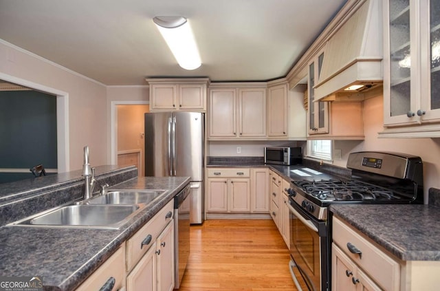 4714 Marc Ct SW, Lilburn, GA 30047 - kitchen with appliances with stainless steel finishes, custom exhaust hood, light wood finished floors, dark countertops, and ornamental molding
