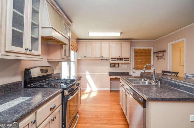 4714 Marc Ct SW, Lilburn, GA 30047 - kitchen featuring appliances with stainless steel finishes, light wood-type flooring, dark countertops, custom exhaust hood, and cream cabinetry