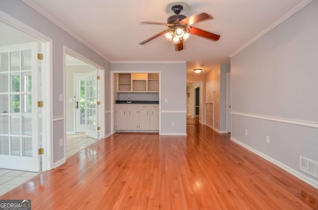 4714 Marc Ct SW, Lilburn, GA 30047 - unfurnished living room featuring a ceiling fan, light wood-style flooring, and ornamental molding