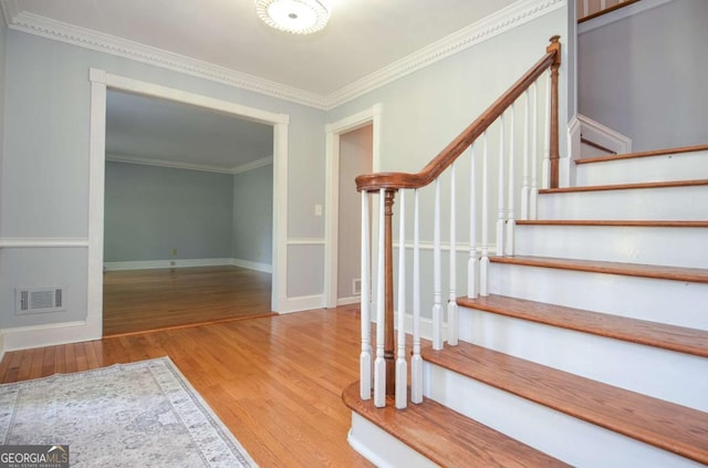 4714 Marc Ct SW, Lilburn, GA 30047 - stairs featuring wood finished floors and crown molding