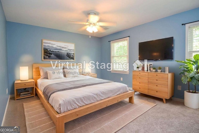 4714 Marc Ct SW, Lilburn, GA 30047 - carpeted bedroom featuring multiple windows and ceiling fan