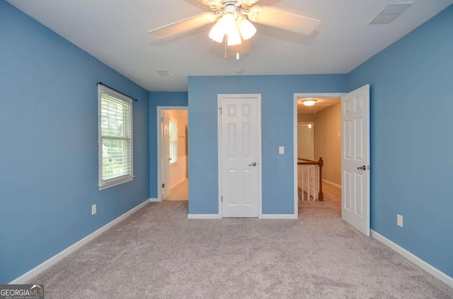 4714 Marc Ct SW, Lilburn, GA 30047 - unfurnished bedroom featuring carpet and a ceiling fan