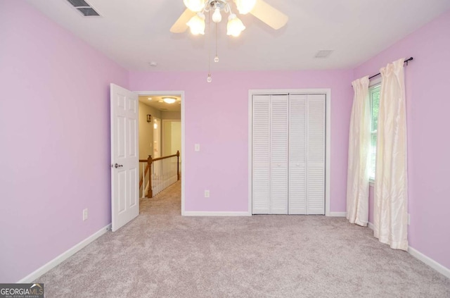 4714 Marc Ct SW, Lilburn, GA 30047 - unfurnished bedroom featuring carpet floors, a closet, and a ceiling fan