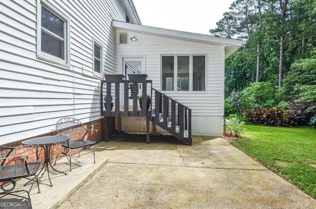 4714 Marc Ct SW, Lilburn, GA 30047 - view of exterior entry featuring a patio and a yard