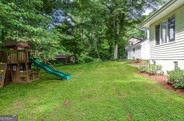 4714 Marc Ct SW, Lilburn, GA 30047 - view of grassy yard featuring a playground