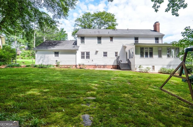 4714 Marc Ct SW, Lilburn, GA 30047 - back of property featuring a chimney and a yard
