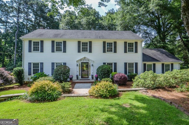 4714 Marc Ct SW, Lilburn, GA 30047 - colonial-style house with a front yard and a chimney