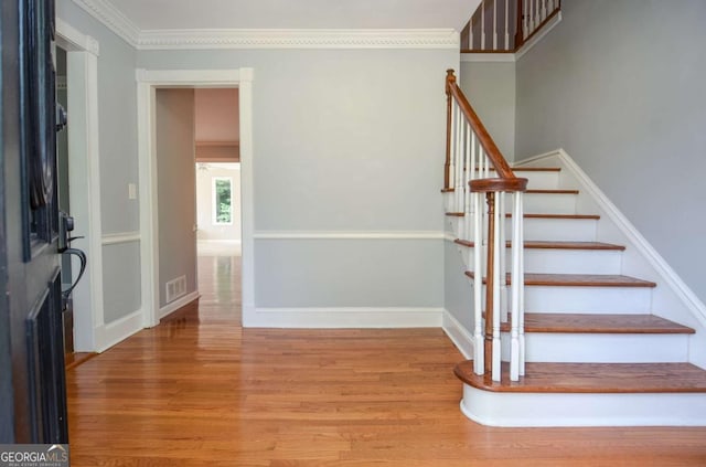 4714 Marc Ct SW, Lilburn, GA 30047 - entrance foyer with wood finished floors, stairway, and ornamental molding