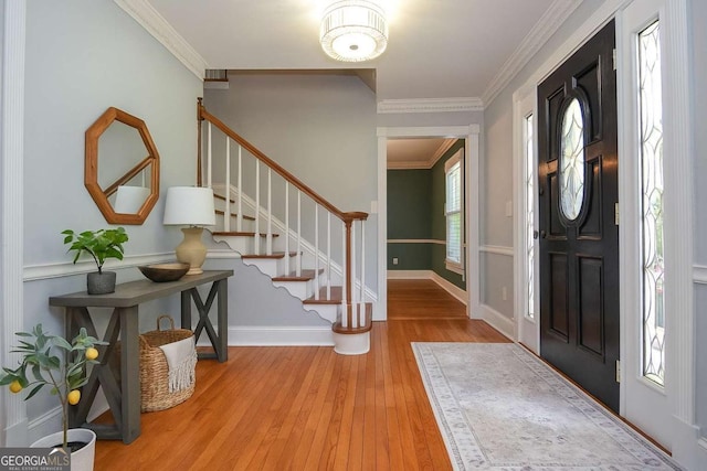 4714 Marc Ct SW, Lilburn, GA 30047 - entryway featuring hardwood / wood-style flooring, stairway, and ornamental molding
